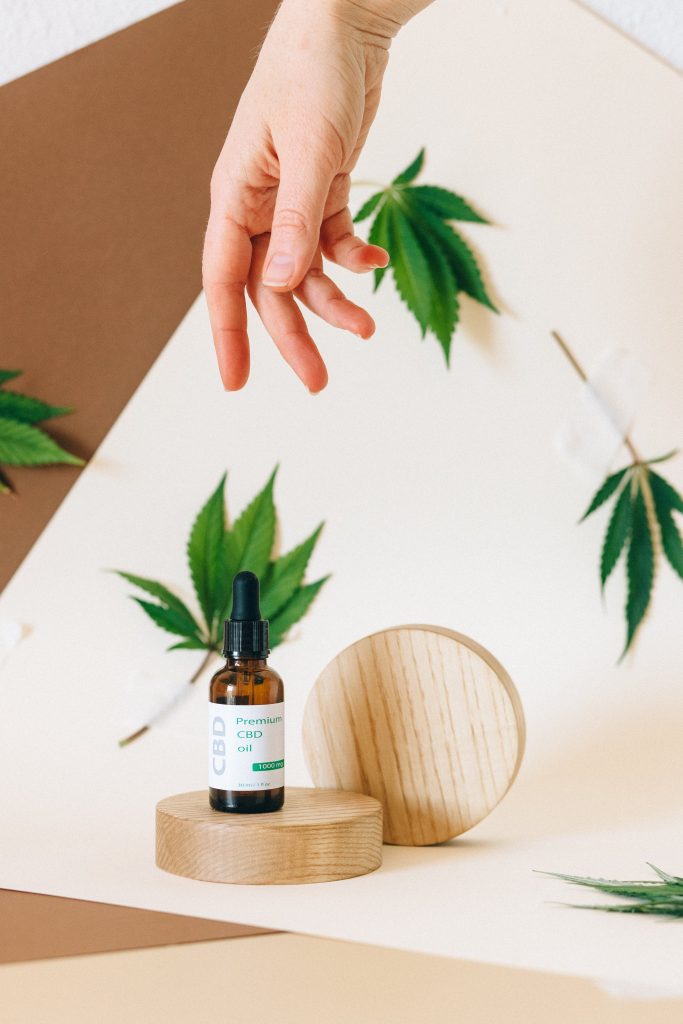 A Hand Over a CBD Product